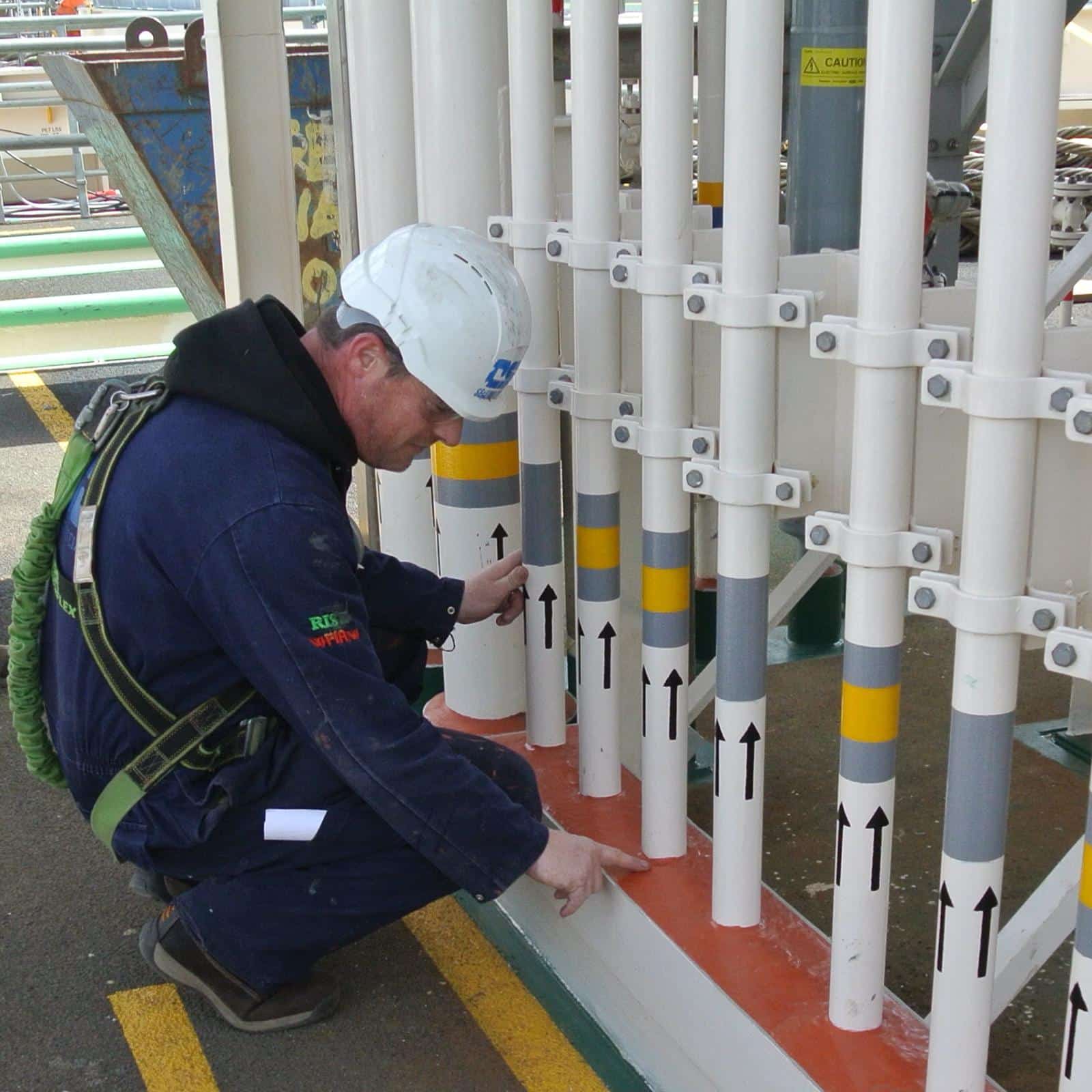 Man inspecting seal on pipe work