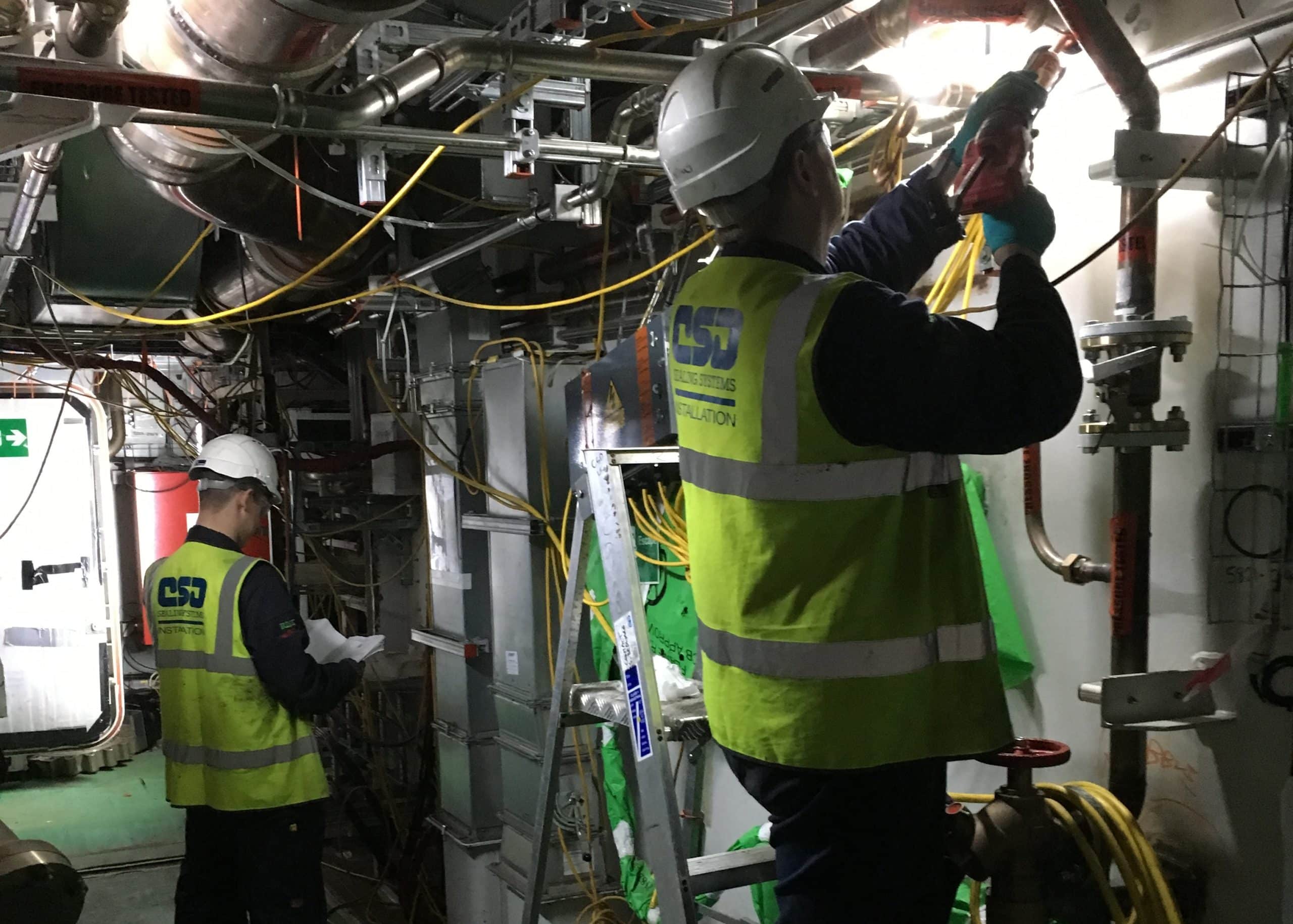 People sealing overhead conduit