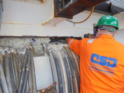 CSD Employee working on pipes going through seal