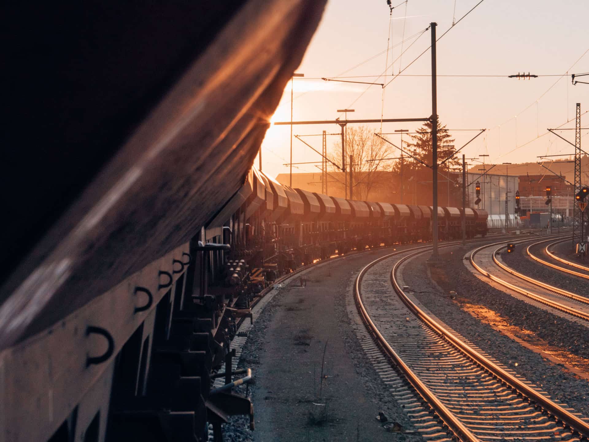 Cargo train on railway at sunset