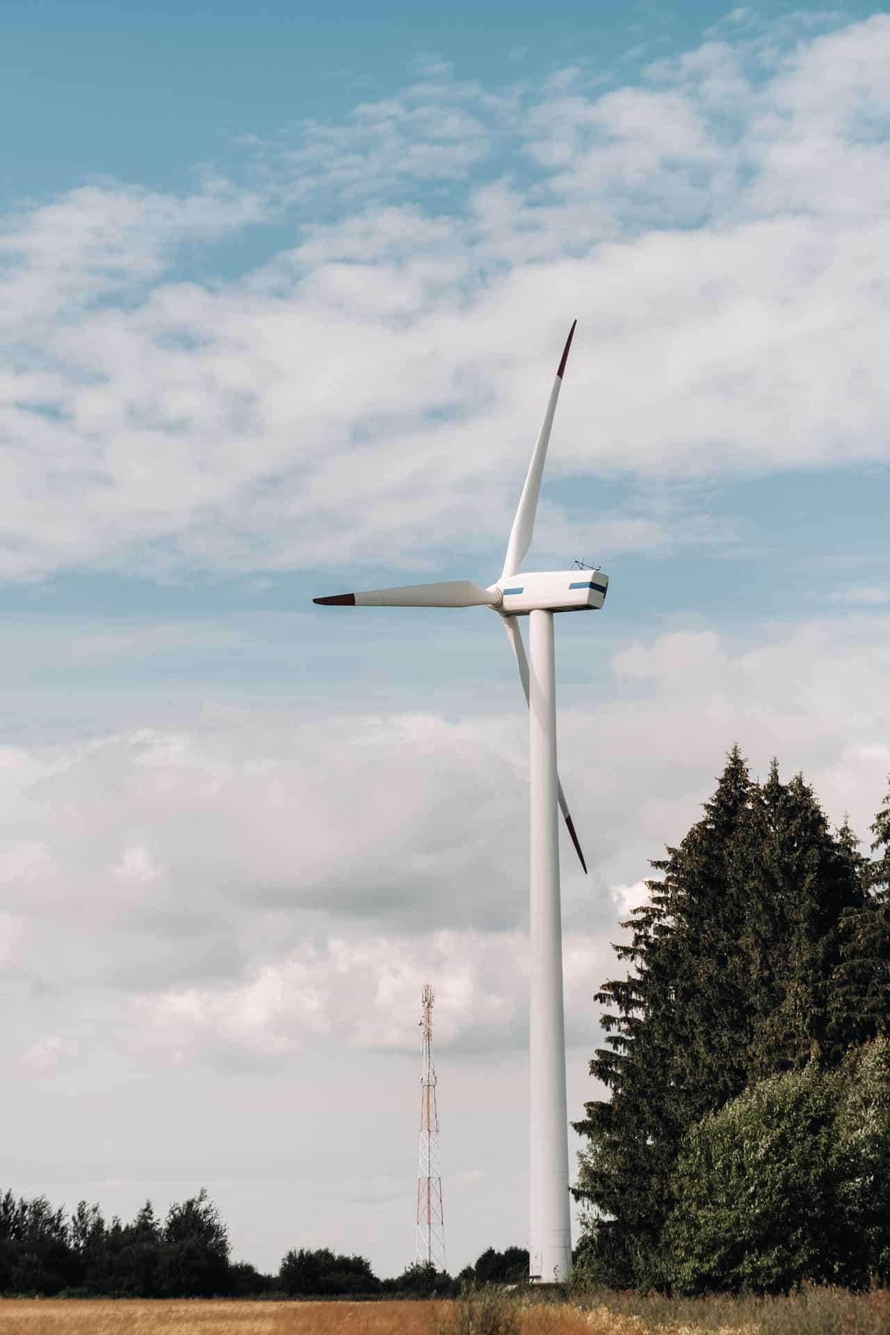 Wind turbine in front of telecommunications tower