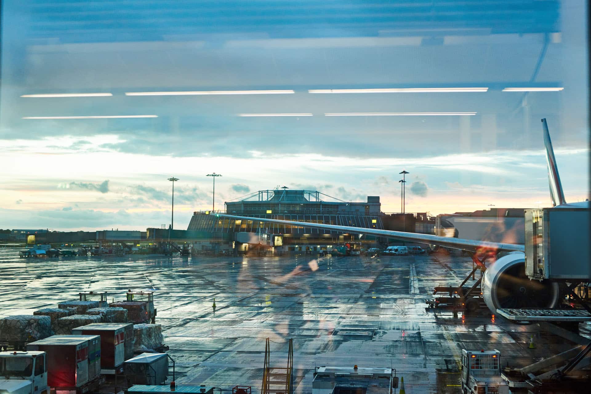 Airplane wing viewed out of departure gate window