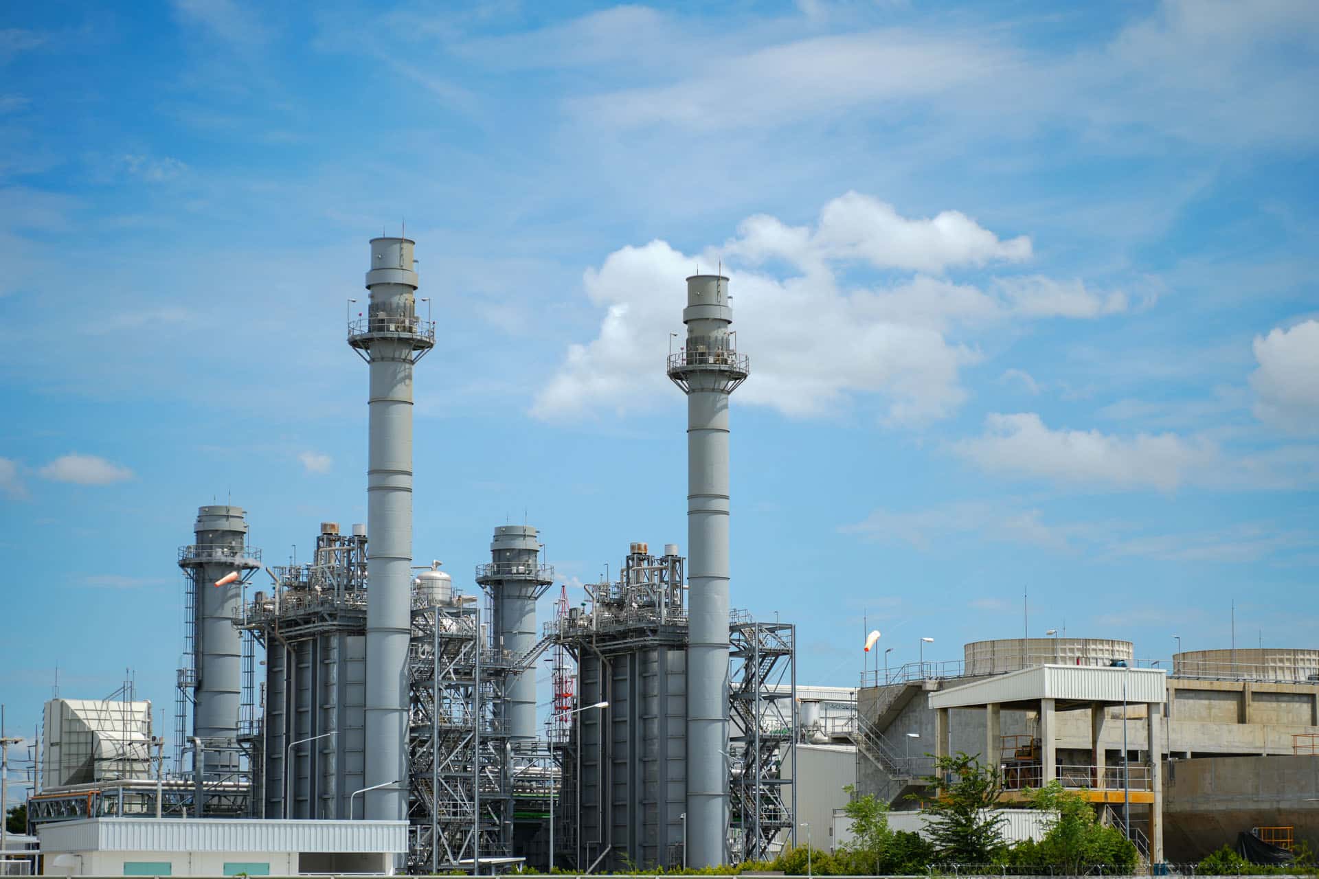 Industrial towers agains a partly cloudy sky