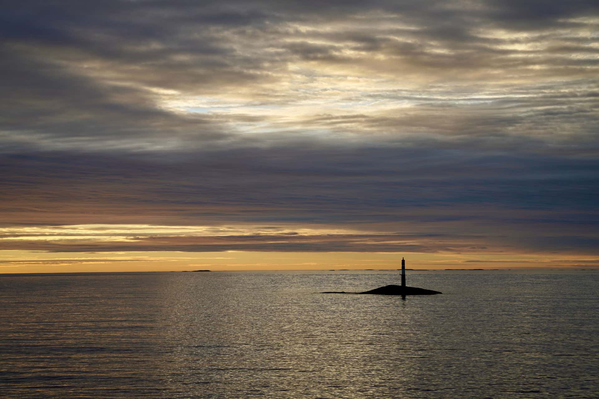 Submarine mostly submerged at sea