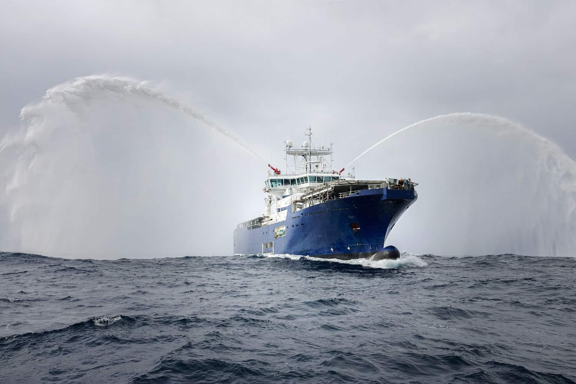 Tugboat spraying fire hoses out at sea