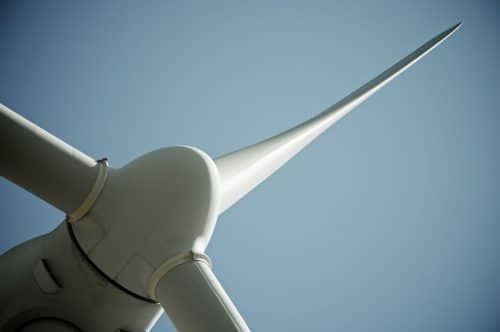 Close up view looking up at wind turbine blades